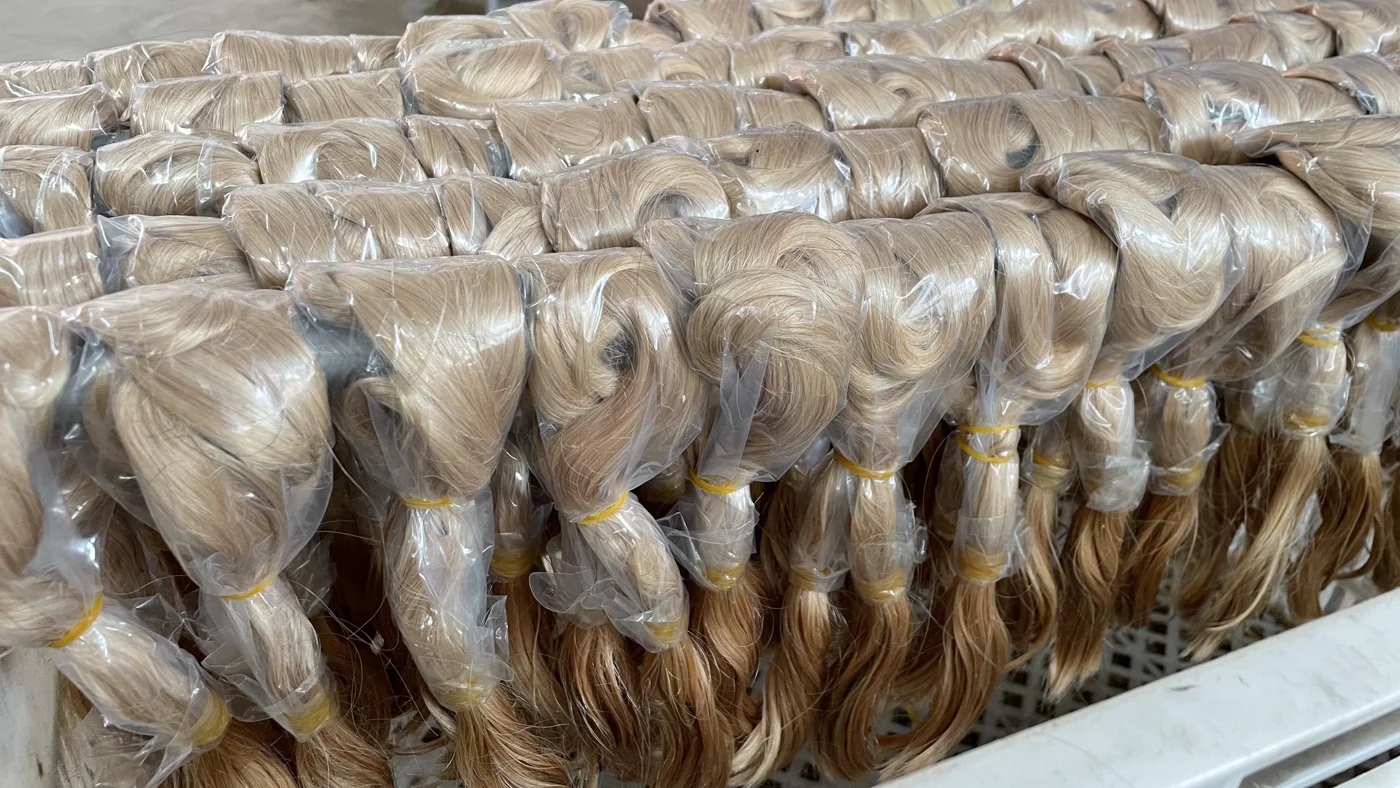Individually bagged hair bundles arranged in batches.