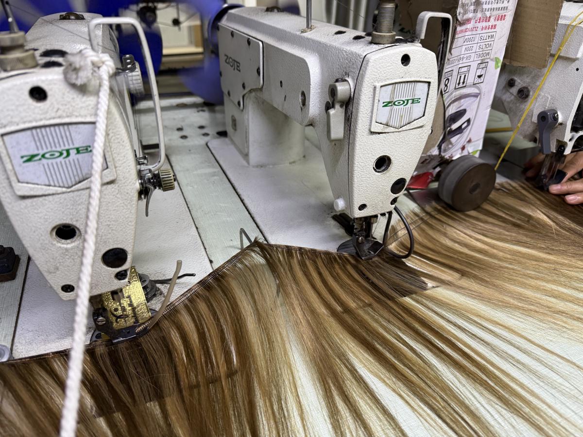 Close-up of KS hair weft sewing with blended human hair
