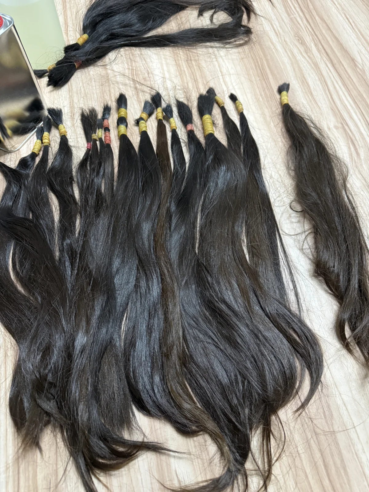 Close-up of individual raw hair bundles laid out for inspection